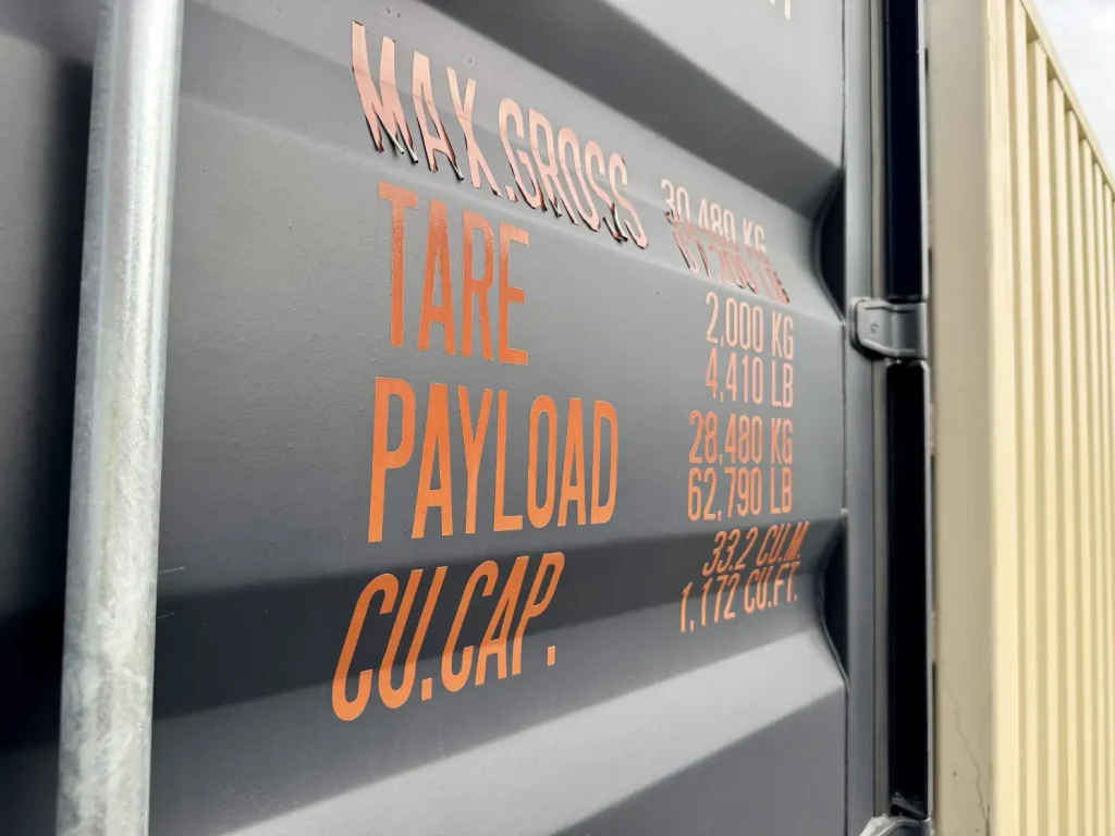 Shipping container data plate showing max gross weight, tare, payload and cubic capacity