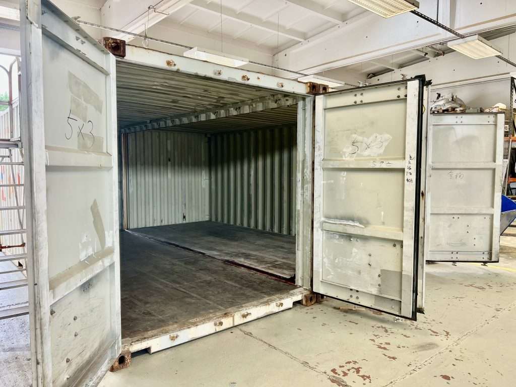 Inside a double wide container garage with the inner walls removed