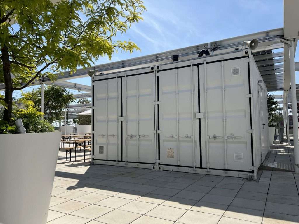 Converted containers with closed doors on the rooftop terrace