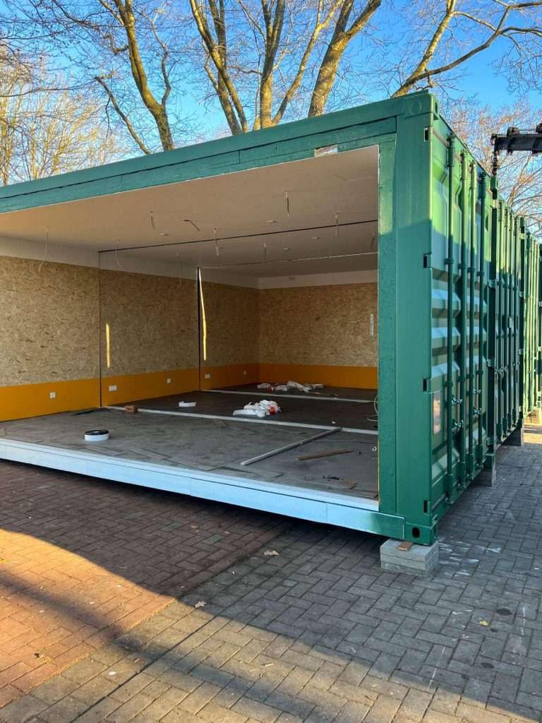 Container classroom under construction with a reinforced open-plan frame