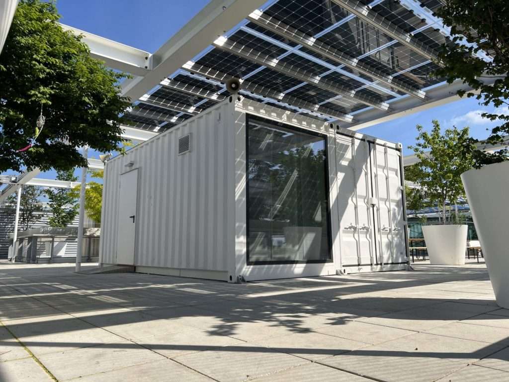 Rooftop container bar unit under a solar canopy