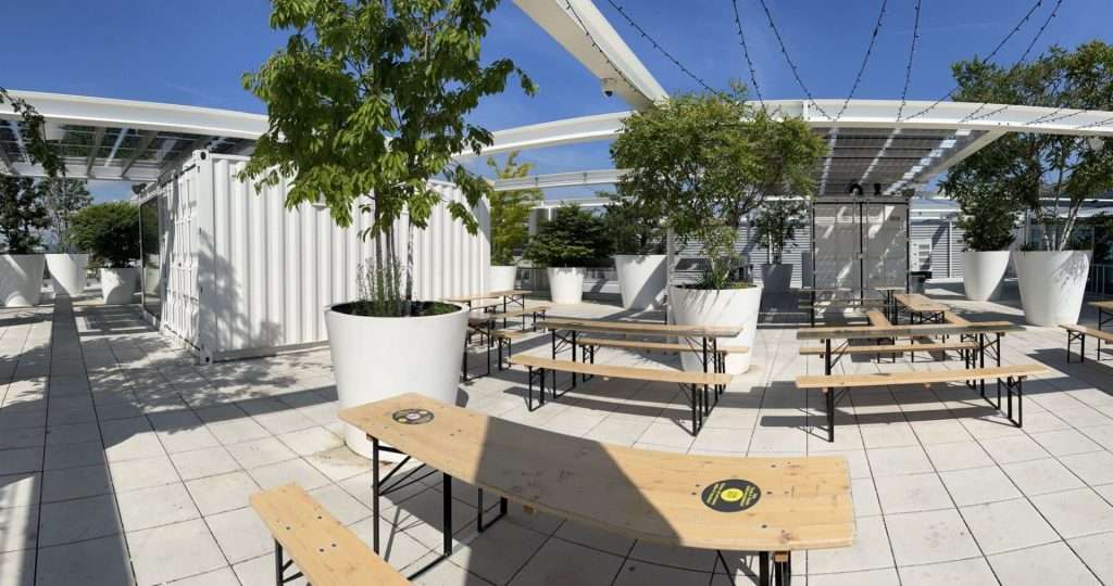 Rooftop terrace with container bars and seating