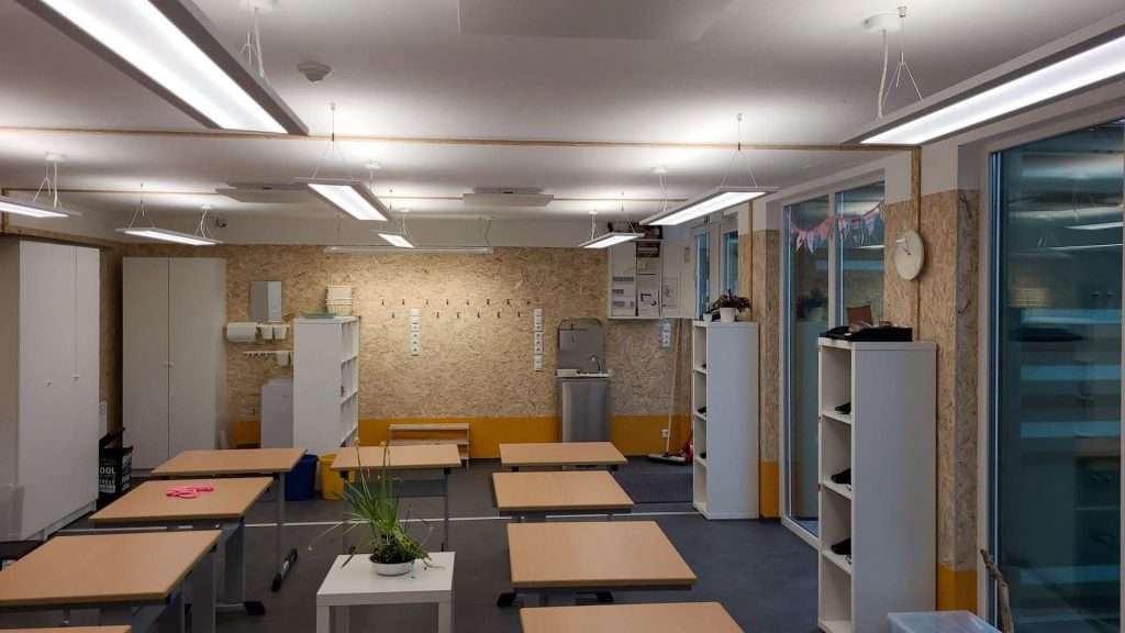 Finished shipping container classroom with desks and daylight